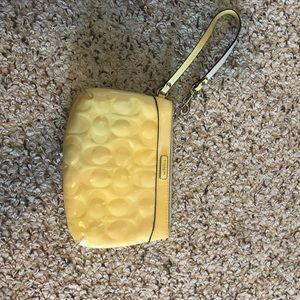 Creamy/yellow Coach wristlet
